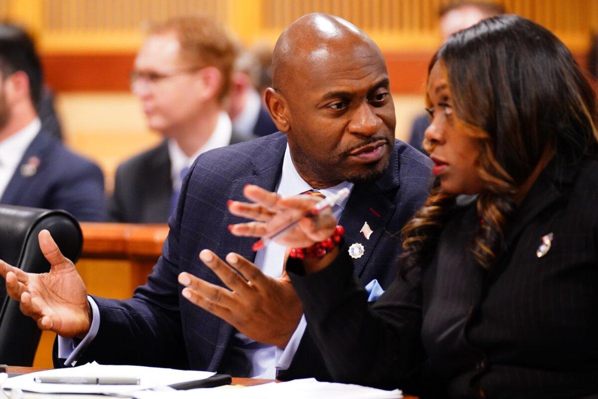 Fulton County special prosecutor Nathan Wade (L) and executive district attorney Daysha Young confer during a hearing in the 2020 Georgia election interference case at the Fulton County Courthouse, in Atlanta, on Dec. 1, 2023. (John David Mercer/Pool/Getty Images)