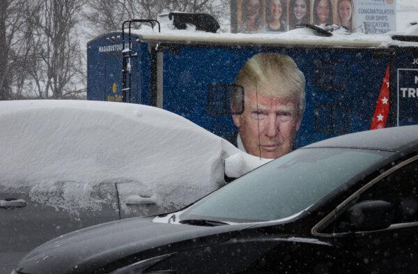A photo of Former President Donald Trump sits on the side of an R.V during a winter storm in Des Moines, Iowa, on Jan. 12, 2024. (John Fredricks/The Epoch Times)
