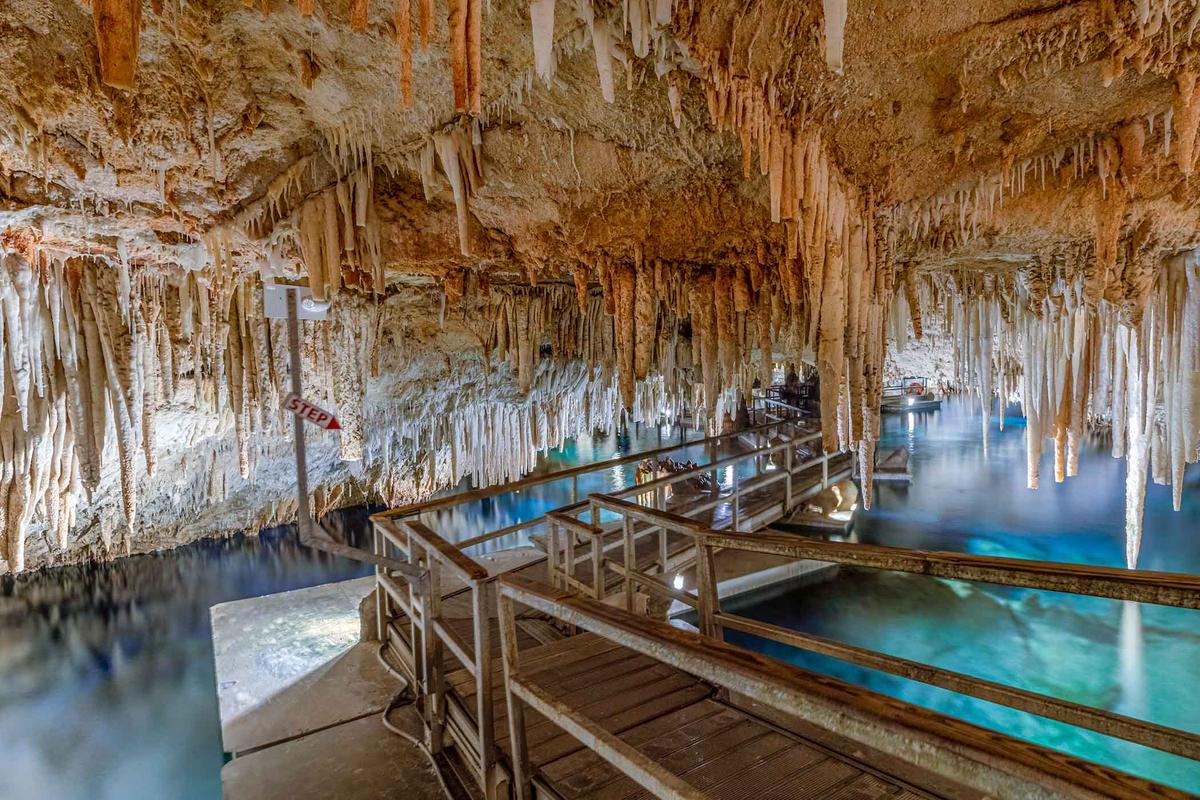 Tourists may explore the Crystal Caves along a floating catwalk. (Scott Heaney/Shutterstock)