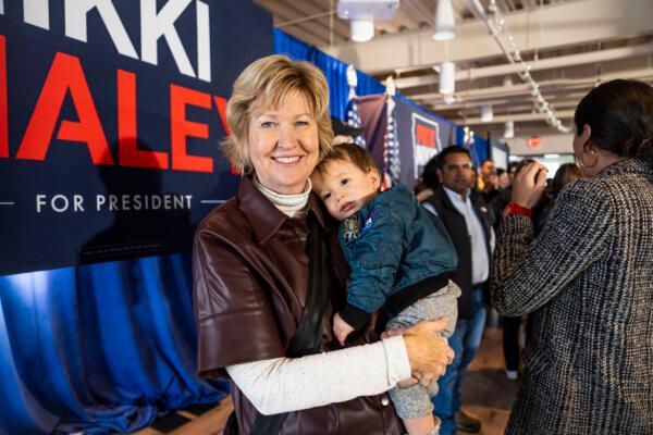 Monica Newendorp from Pella, Iowa, holds her grandson during Republican presidential candidate South Carolina Gov. Nikki Haley’s campaign event in Ankeny, Iowa, on Jan. 11, 2024. (Madalina Vasiliu/The Epoch Times)