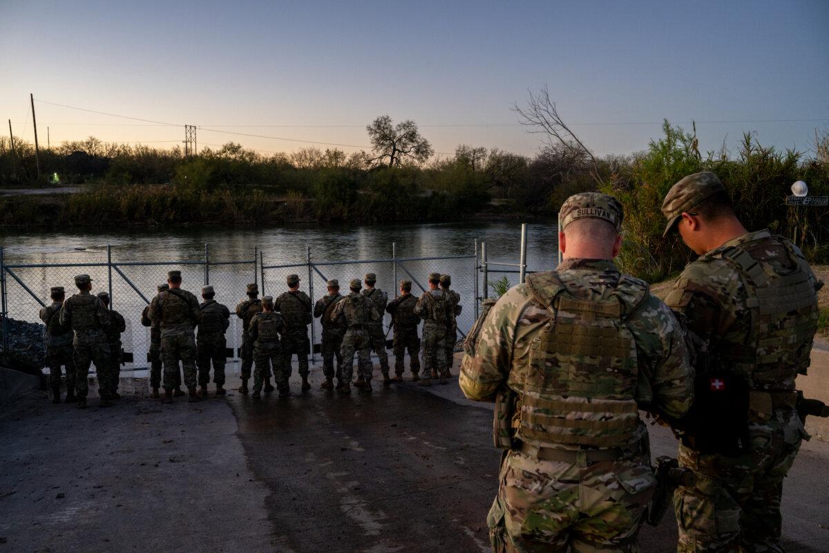 National Guard soldiers stand guard on the banks of the Rio Grande River at Shelby Park in Eagle Pass, Texas, on Jan. 12, 2024. (Brandon Bell/Getty Images)