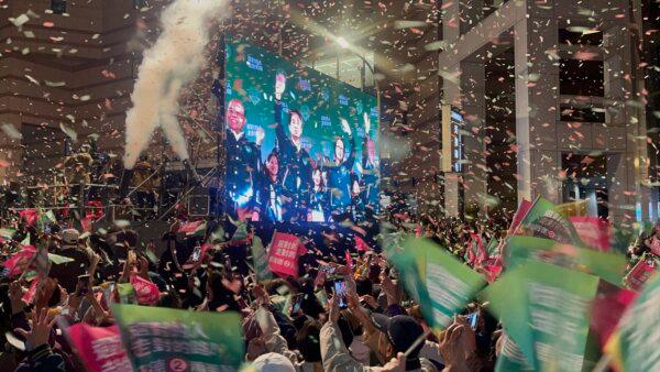 Supporters of Democratic Progressive Party President-elect Lai Ching-te celebrate the election returns in Taipei, Taiwan, on Jan. 13, 2024. (Melina Chan/The Epoch Times)