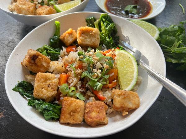 Crispy tofu adds plant-based protein to a bowl of crispy rice topped with spinach, crushed cashews and chopped scallions. (Gretchen McKay/Pittsburgh Post-Gazette/TNS)