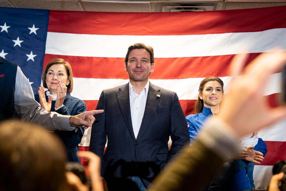 (L-R) Iowa Gov. Kim Reynolds, Republican presidential candidate Florida Gov. Ron DeSantis, and his wife Casey DeSantis holding their son Mason during a campaign event in West Des Moines, Iowa, on Jan. 13, 2024. (Madalina Vasiliu/The Epoch Times)