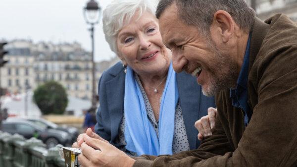 Madeleine (Line Renaud, L) and Charles (Dany Boon) enjoy each other’s company, in “Driving Madeleine.” (Pathé)