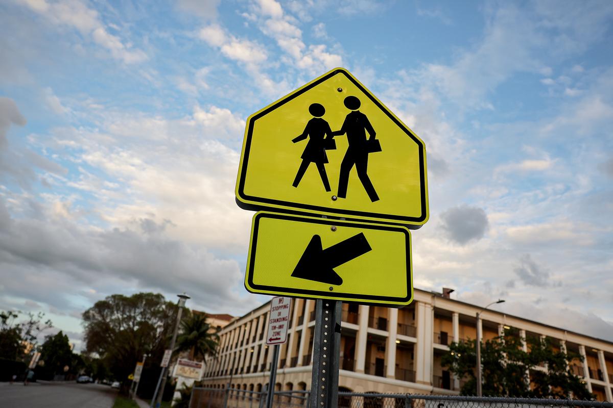 A school crossing sign warns drivers in front of an elementary school in Miami on April 19, 2023. (Joe Raedle/Getty Images)