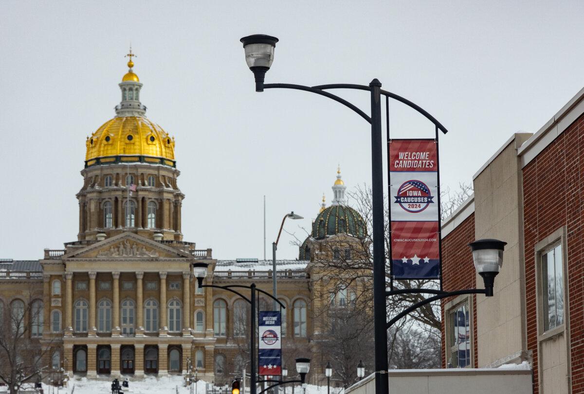 Advertising for the Iowa caucus line the streets of Des Moines, Iowa, Jan. 15, 2024. (John Fredricks/The Epoch Times)