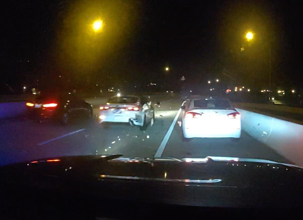 A white Kia is seen driving off without stopping from the cruiser's dash cam after the incident. (Courtesy of St. Petersburg Police Department)