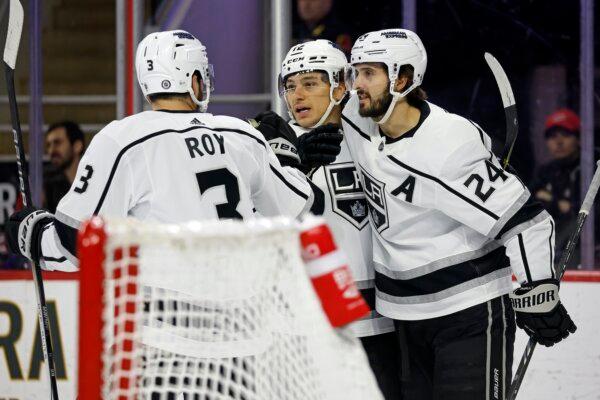 Los Angeles Kings' Trevor Moore (C) celebrates after his goal with teammates Phillip Danault (24) and Matt Roy (3) during the first period of an NHL hockey game against the Carolina Hurricanes in Raleigh, N.C., on Jan. 15, 2024. (Karl B DeBlaker/AP Photo)
