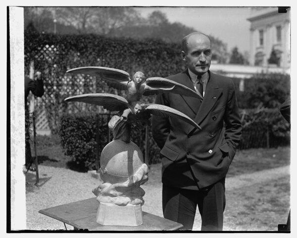 Lt. Carl Ben Eielson stands beside the Harmon trophy, presented to him in 1929 by President Herbert Hoover. (Library of Congress/LCCN2016843613)