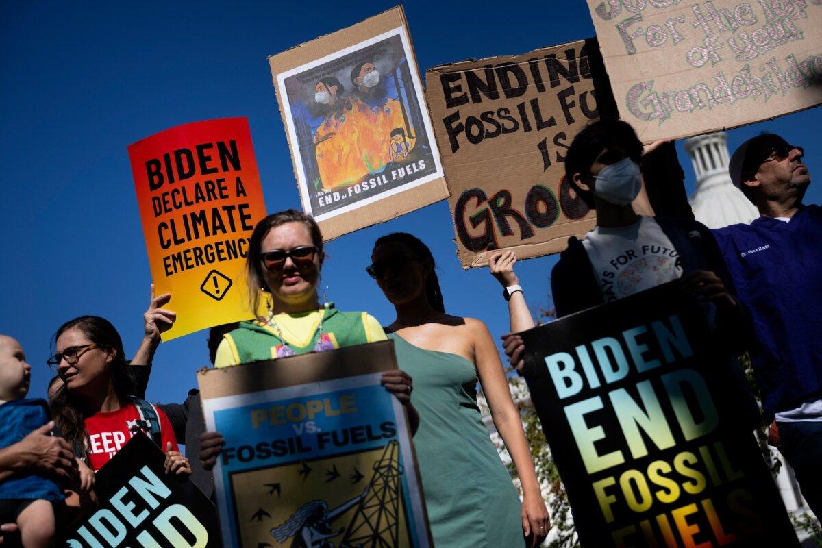 People gather for a rally to urge President Biden to use his executive powers to stop approving fossil fuel projects and declare a climate emergency, on Capitol Hill on Sept. 14, 2023. (Brendan Smialowski / AFP via Getty Images)