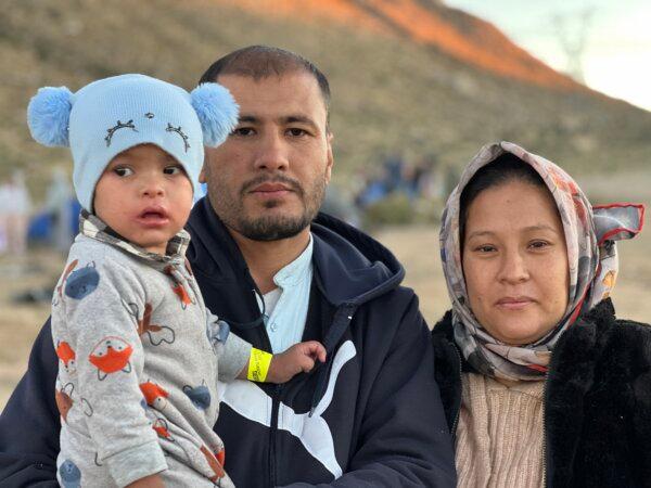 Allhadad Mutjaba, a former communications officer for the Afghan army in Afghanistan, at the Moon camp east of Jacumba, Calif., with his wife and young son after crossing the U.S.–Mexico border on Dec. 5, 2023. (Brad Jones/The Epoch Times)