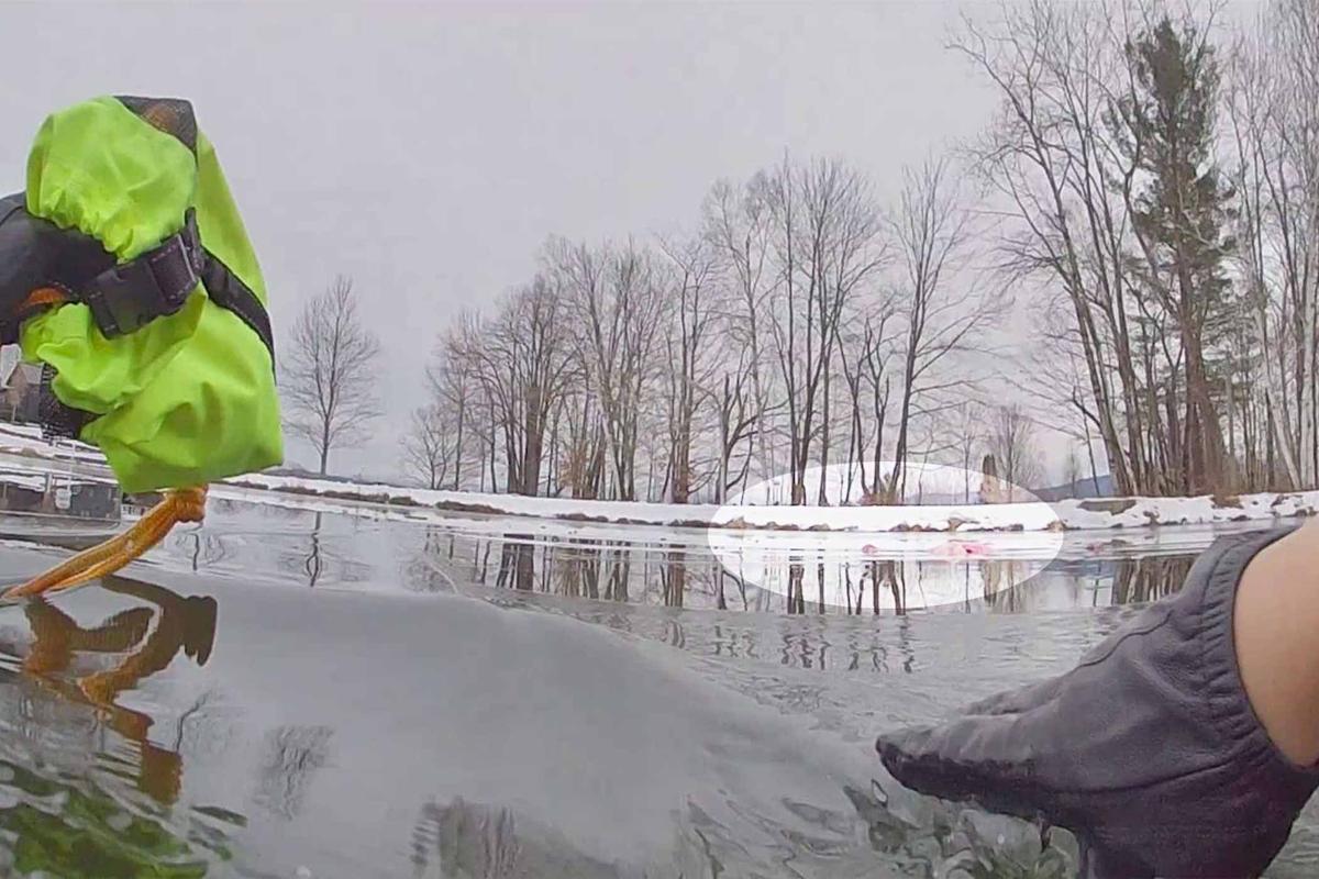 Trooper Archer enters the bitterly cold water without hesitation to rescue the girl. (Courtesy of Vermont State Police)