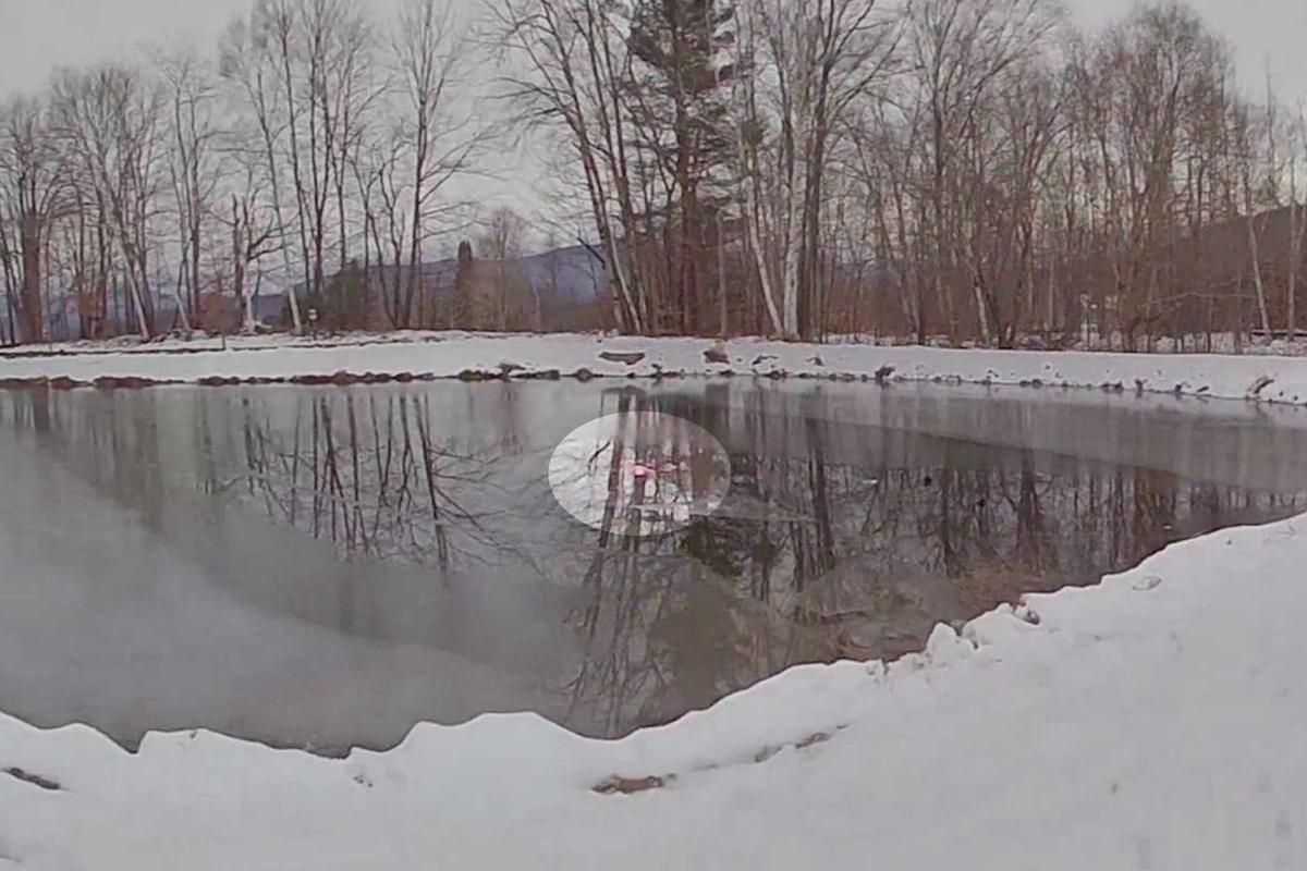 A screen capture of footage taken from Trooper Archer's body camera shows the rescue of an 8-year-old girl submerged in a frozen pond. (Courtesy of Vermont State Police)