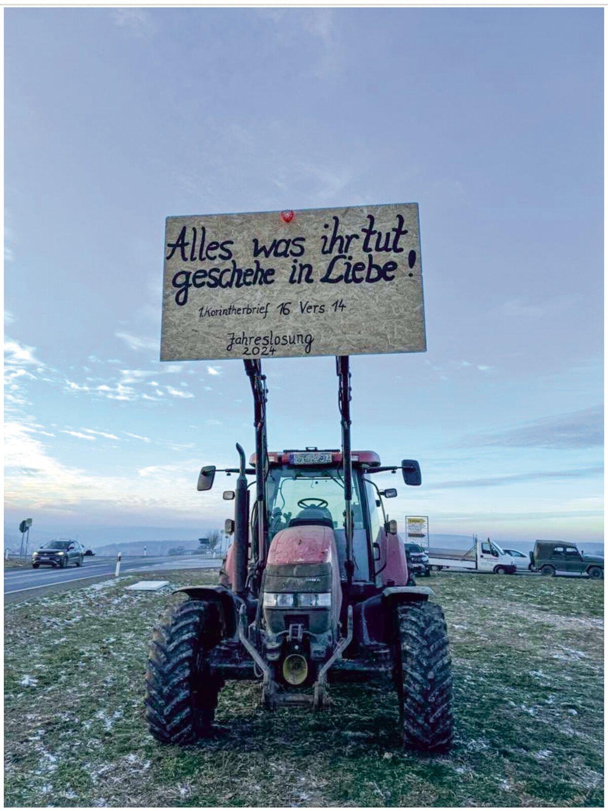 A tractor holds a placard with a Bible verse on it at a farmers’ protest in Vogtland near Greiz, Germany, on Jan. 11, 2024. (TS/THE EPOCH TIMES)