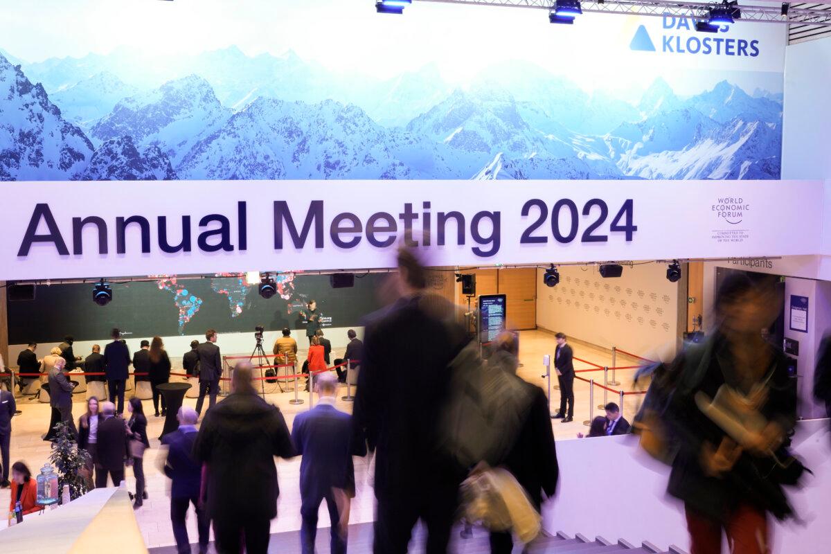 People walk down the stairs at the Congress Hall during the World Economic Forum in Davos, Switzerland, on Jan. 18, 2024. The annual meeting of the World Economic Forum is taking place in Davos from Jan. 15 until Jan. 19, 2024.(AP Photo/Markus Schreiber)