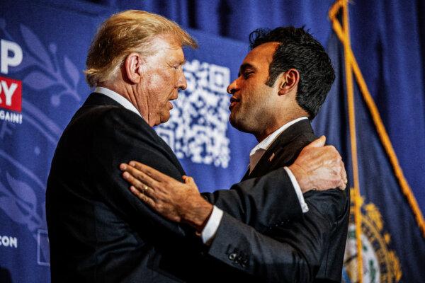 Republican presidential candidate and former President Donald Trump greets entrepreneur Vivek Ramaswamy while speaking during a campaign rally at the Atkinson Country Club in Atkinson, N.H., on Jan. 16, 2024. (Brandon Bell/Getty Images)