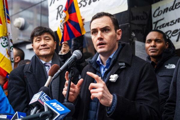 Next to Zhou Fengsuo (L), executive director of Human Rights in China, Rep. Mike Gallagher (R-Wis.) speaks at a press conference and rally in front of the America ChangLe Association (A now-closed overseas Chinese police station is located inside the association building.) highlighting Beijing's transnational repression, in New York City, on Feb. 25, 2023. (Samira Bouaou/The Epoch Times)