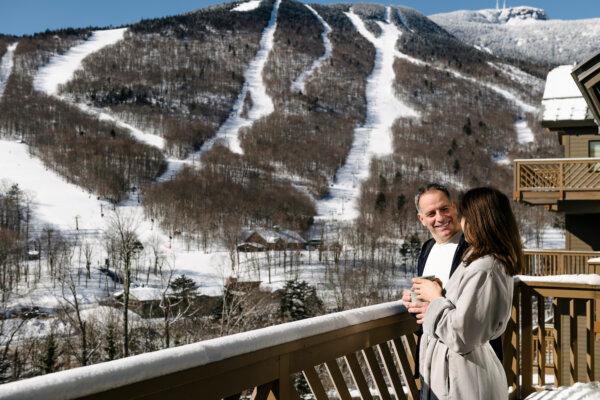 A couple enjoys morning coffee and takes in the view of Mt. Mansfield from their hotel balcony at the Lodge at Spruce Peak. (Courtesy of the Lodge at Spruce Peak)