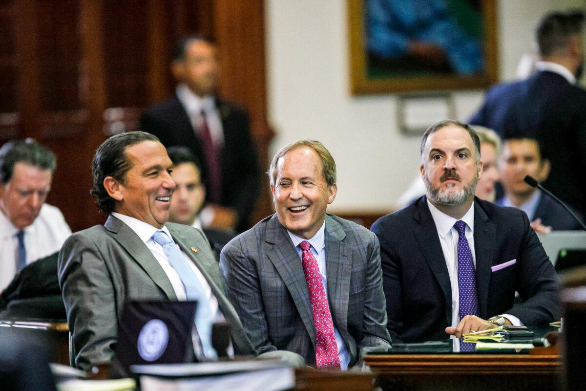 Texas Attorney General Ken Paxton (center) sits between defense attorneys Tony Buzbee (left) and Mitch Little (right) before his impeachment trial resumes in the Senate Chamber at the Texas Capitol, in Austin, Texas, on Sept. 15, 2023. (Sam Owens/The San Antonio Express-News via AP, Pool)