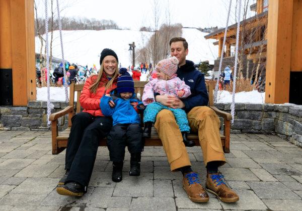 A young family enjoys some <span class="Apple-converted-space">après</span> ski time on a chair swing in Spruce Peak Village at Stowe Mountain Resort (Courtesy of Stowe Mountain Resort)