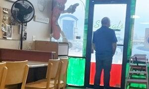 Army Guard Posts Photo of Restaurant Owner Looking Out the Door for Customers—The Response Has Been Overwhelming