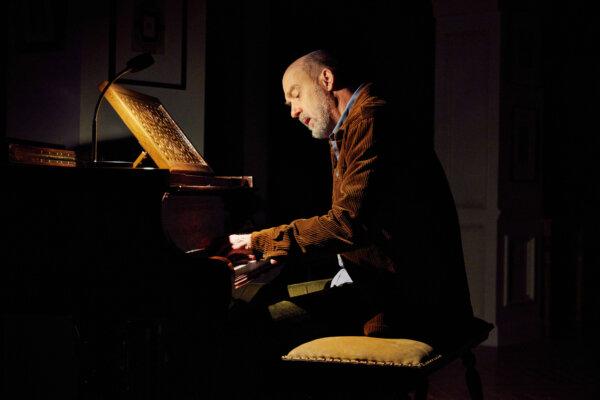 Patrick Salomon (Anthony Edwards) plays the piano, in "Prayer for the French Republic." (©Jeremy Daniel, 2023)