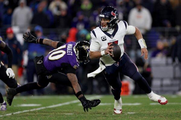 C.J. Stroud (7) of the Houston Texans scrambles against Arthur Maulet (10) of the Baltimore Ravens during the fourth quarter in the AFC Divisional Playoff game in Baltimore on Jan. 20, 2024. (Patrick Smith/Getty Images)