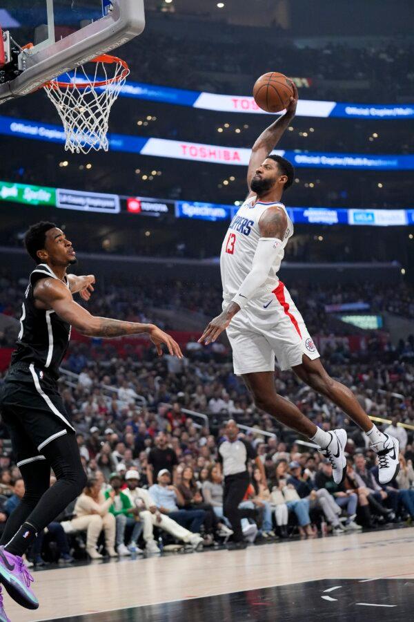 Los Angeles Clippers forward Paul George (13) dunks over Brooklyn Nets center Nic Claxton during the first half of an NBA basketball game in Los Angeles on Jan. 21, 2024. (Marcio Jose Sanchez/AP Photo)