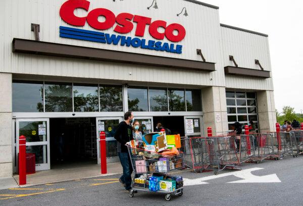 Shoppers walk out with full carts from a Costco store in Washington on May 5, 2020. (Nicholas Kamm/AFP via Getty Images)