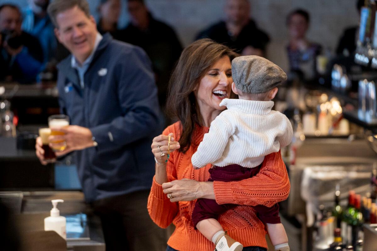 Republican presidential candidate and former U.N. Ambassador Nikki Haley holds Arthur Coweete, 16 months, from Bow, N.H., during a campaign event at T-BONES Great American Eatery restaurant in Concord, N.H., on Jan. 22, 2024. (Madalina Vasiliu/The Epoch Times)