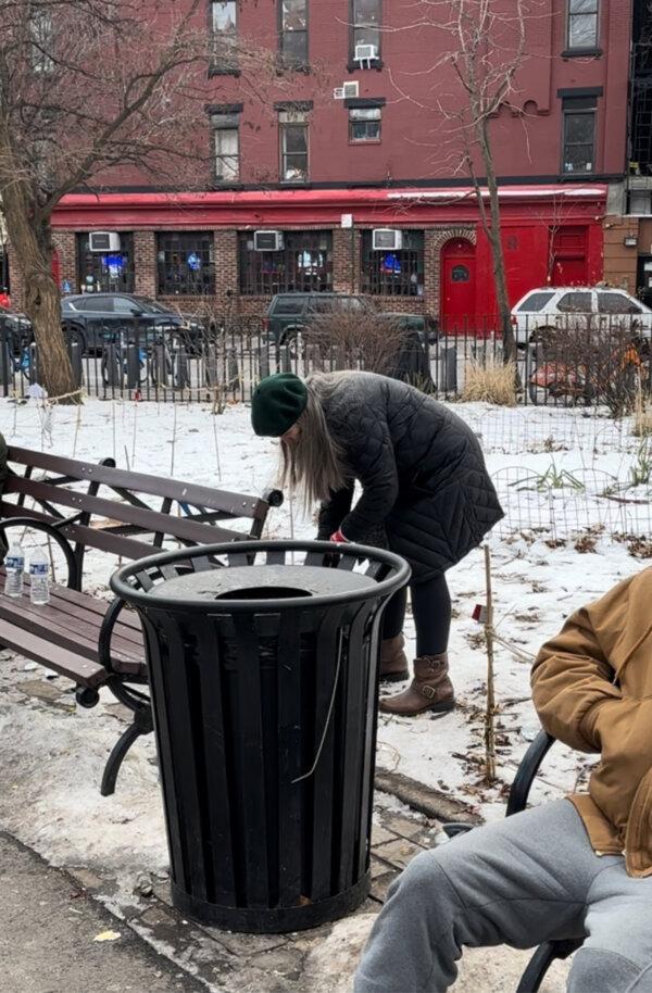 A volunteering neighbor who identified herself only as Catherine picks up litter after lunch in the park, on Jan. 22, 2024 (Juliette Fairley)