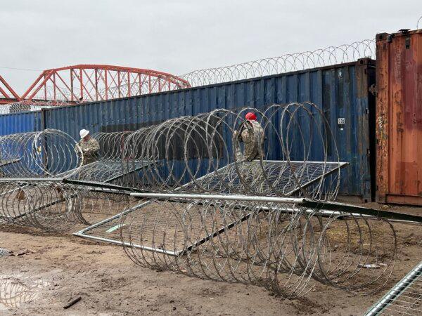 Texas National Guard members put up more barriers at Shelby Park, on the U.S.–Mexico border, in Eagle Pass, Texas, on Jan. 23, 2024. (Charlotte Cuthbertson/The Epoch Times)