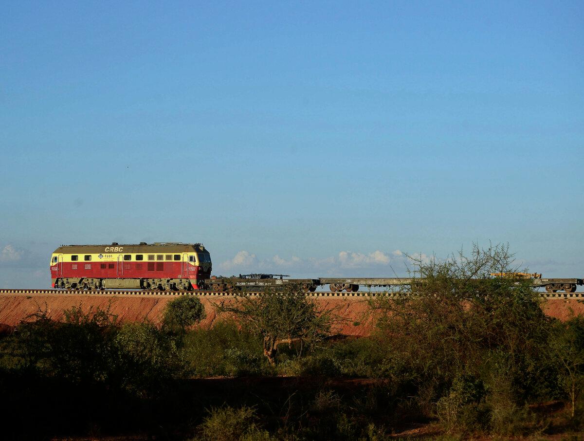 A locomotive hauling cargo cars runs along an elevated section of the new Standard Gauge Railway near Voi, Kenya, about 206 miles southeast of Nairobi, Kenya, on March 16, 2016. (Tony Karumba/AFP via Getty Images)