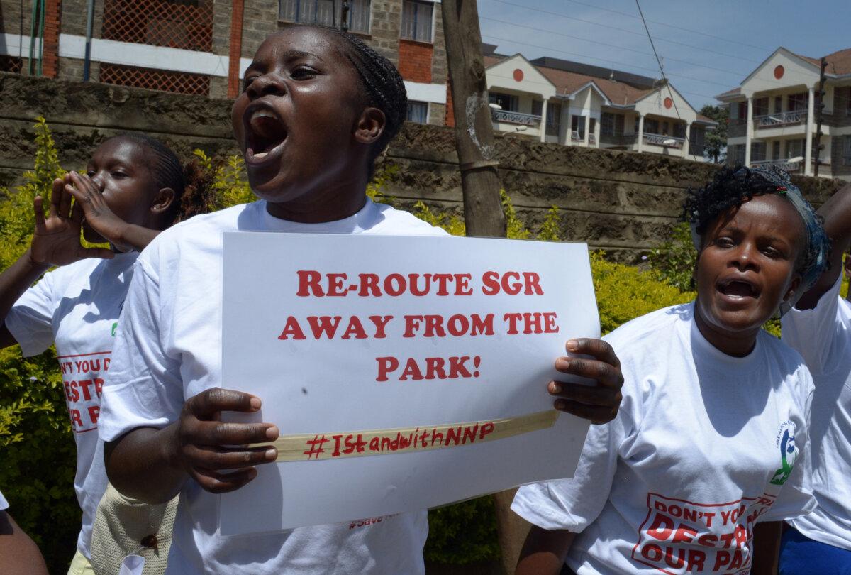 Members of communities living next to the Nairobi National Park take part in a demonstration on Oct. 17, 2016, outside the People's Republic of China Embassy in Nairobi, Kenya, to protest against the planned route of the Standard Gauge Railway (SGR) being built by China that would cut through the Nairobi National Park. (Simon Maina/AFP via Getty Images)