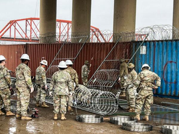 Texas National Guard works to place razor wire and barriers at Shelby Park on the U.S.–Mexico border, in Eagle Pass, Texas, on Jan. 23, 2024. (Charlotte Cuthbertson/The Epoch Times)