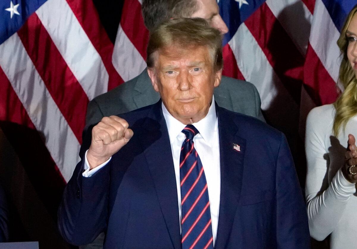 Republican presidential hopeful and former President Donald Trump celebrates his victory at a primary election night party in Nashua, N.H., on Jan. 23, 2024. (Timothy A. Clary/AFP via Getty Images)