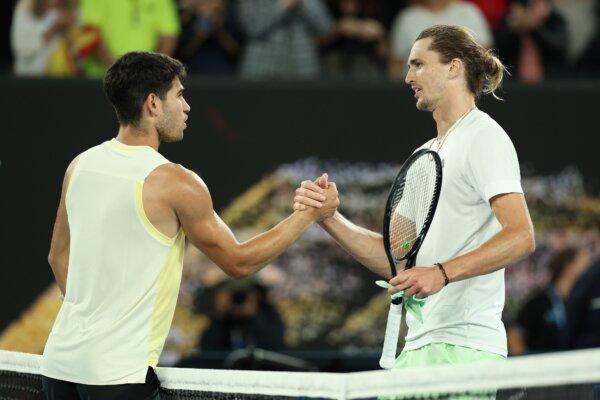 Carlos Alcaraz of Spain and Alexander Zverev of Germany embrace at the net following their quarterfinals singles match during the 2024 Australian Open in Melbourne on Jan. 24, 2024. (Cameron Spencer/Getty Images)