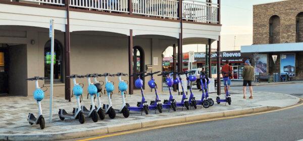 A selection of e-scooters available for hire can be seen on the corner of a street in Albany, Western Australia, on Aug. 8, 2023. (Susan Mortimer/The Epoch Times)