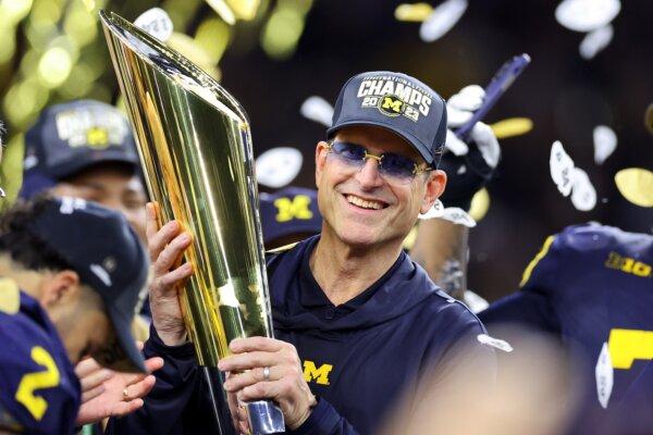 Then head coach Jim Harbaugh of the Michigan Wolverines celebrates after defeating the Washington Huskies during the 2024 CFP National Championship game in Houston on Jan. 8, 2024. (Stacy Revere/Getty Images)