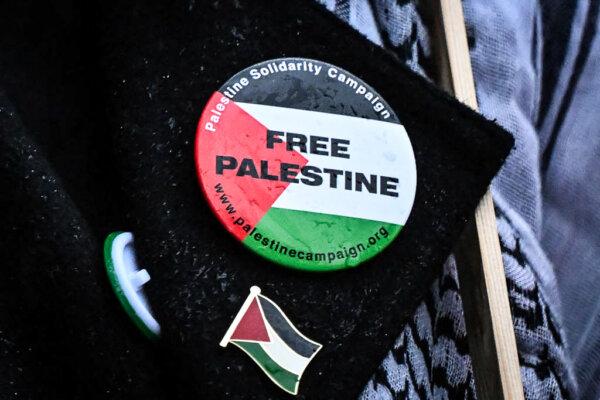 Badges picturing the Palestinian flag and reading a message in support of Palestinians are pinned on the jacket of a protester outside Downing Street, in London, on Oct. 18, 2023. (Justin Tallis/AFP via Getty Images)