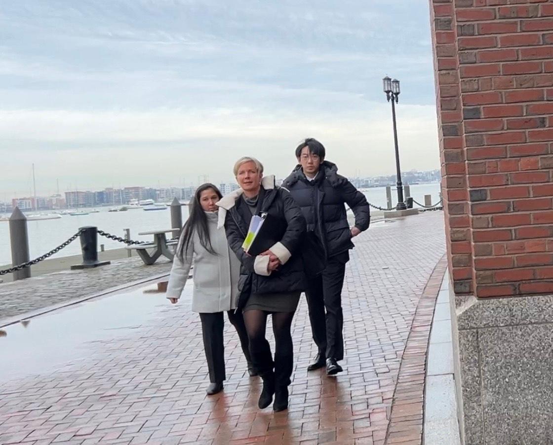 Wu Xiaolei (R) leaves the United States District Court for the District of Massachusetts with his attorneys in Boston on Jan. 25, 2024. (Learner Liu/The Epoch Times)