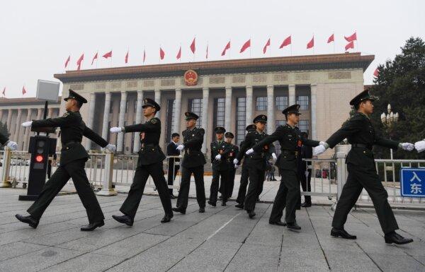 Chinese soldiers march outside the Great Hall of the People in Beijing, before the introduction of the Communist Party of China's Politburo Standing Committee, the nation's top decision-making body, on Oct. 25, 2017. (Greg Baker/AFP via Getty Images)
