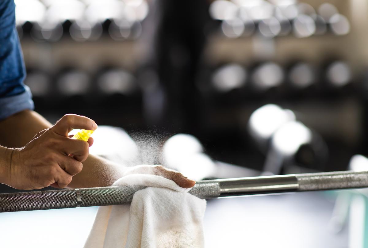 Be considerate and make sure to wipe off any sweat on gym equipment. Bonus points if you use a disinfectant spray too. (BigPixel Photo/Shutterstock)