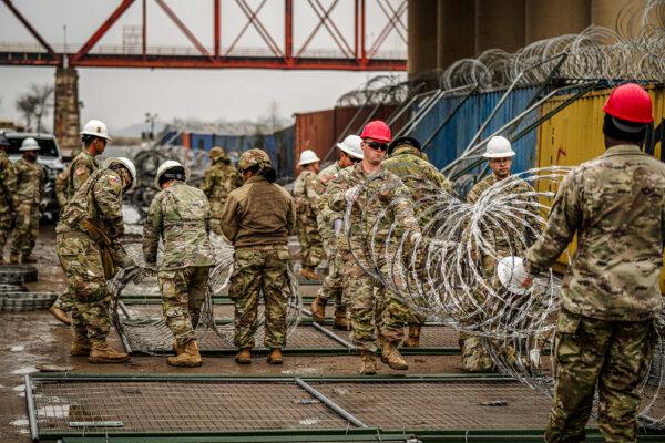 Texas National Guardsmen add razor wire and barriers along the U.S.–Mexico border in Shelby Park, Eagle Pass, Texas, on Jan. 23, 2024. (Charlotte Cuthbertson/The Epoch Times)