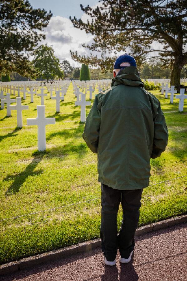 A veteran visits the American Cemetery and Memorial in Normandy, France. (Photo courtesy of Road Scholar/Anibas Photography)