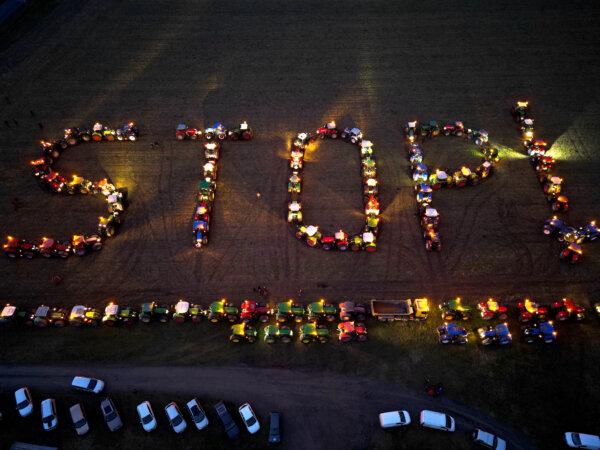 An aerial view shows tractors positioned to read "STOP !" during a farmers' protest over a number of issues affecting their sector, in Maille, central France, on Jan. 23, 2024. (GUILLAUME SOUVANT/AFP)