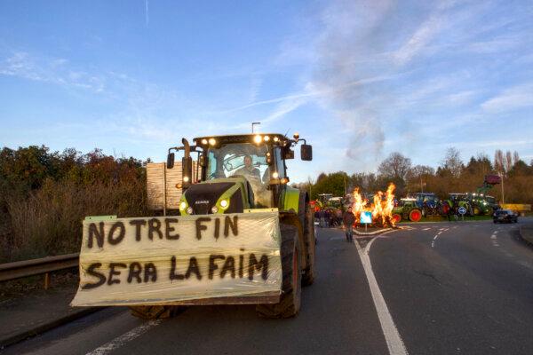 A slogan which reads "Hunger will be our fate" is displayed on a tractor as farmers block the entrance of a Leclerc supermarket in Le Mans, northwestern France, on Jan. 26, 2024, as part of a nationwide day of protests called by several farmers unions on pay, tax and regulations. Farmers have fumed at what they say is a squeeze on purchase prices for produce by supermarket and industrial buyers, as well as complex environmental regulations. (GUILLAUME SOUVANT/AFP)