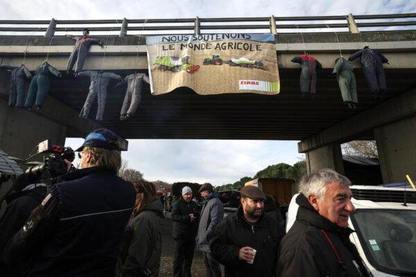 A banner reads "We support the agricultural movement" as farmers block the A64 highway in protest against taxation and declining income, near Carbonne, south of Toulouse, on Jan. 22, 2024. Since January 18, 2024, farmers have been blocking the A64 motorway in Carbonne near Toulouse. In France, as elsewhere in Europe, there has been an increasing number of farmers' demonstrations in recent weeks. (Valentine CHAPUIS/AFP)