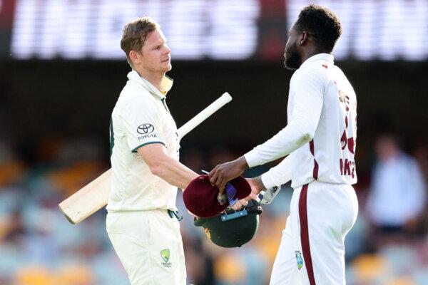 Steve Smith of Australia (L) and Kirk McKenzie of the West Indies interact during day four of the second cricket Test match between Australia and West Indies at the Gabba in Brisbane, Australia, on Jan. 28, 2024. (Pat HOELSCHER/AFP via Getty Images)
